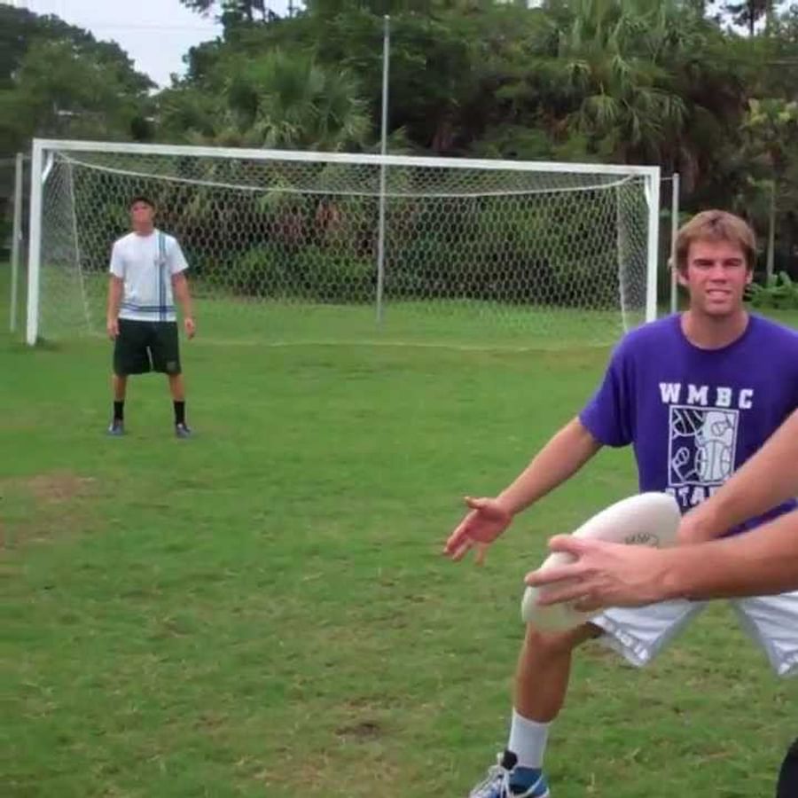 Ultimate Frisbee player executing a Scoober Throw