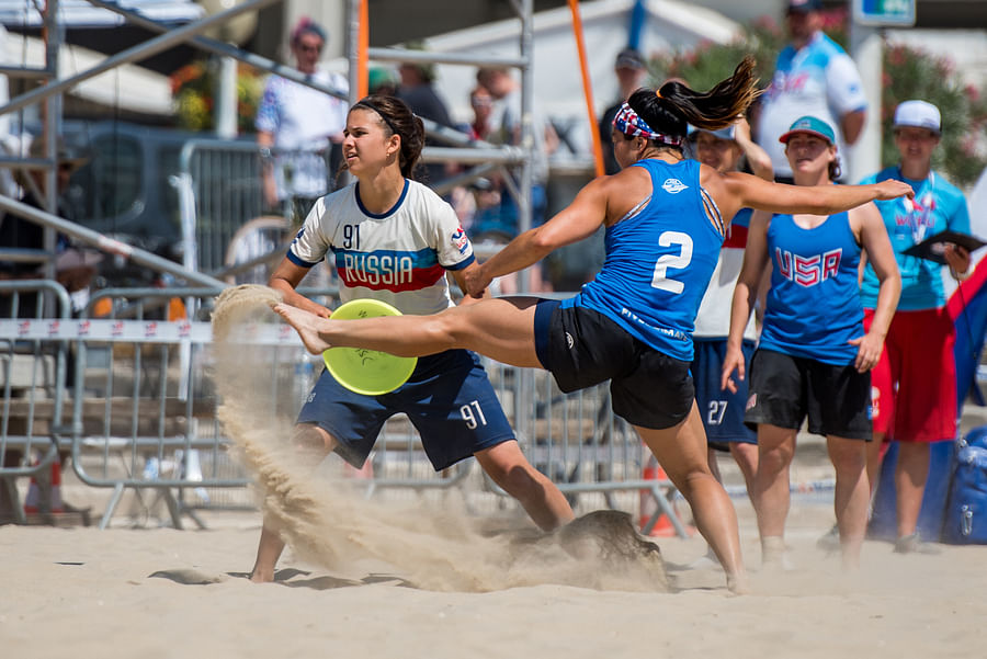 Ultimate Frisbee game on a grass field and beach