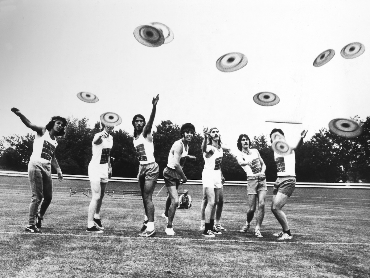 Vintage photo of inventor Walter Frederick Morrison posing with his Flyin-Saucer frisbee